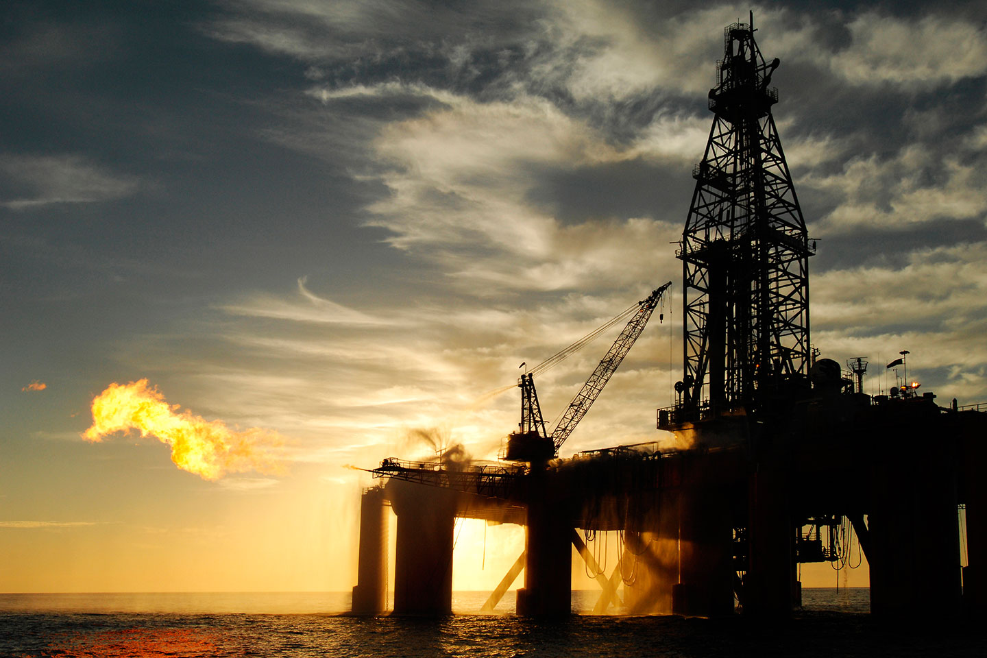 Oil rises 5% on output cuts, demand hopes