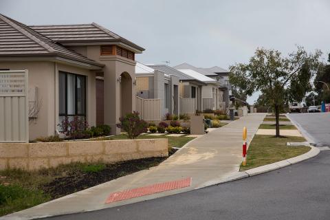 RBA cuts rate to record low amid house price slump