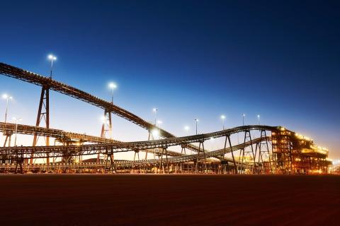 BHP raises iron ore forecast, flags coal hit
