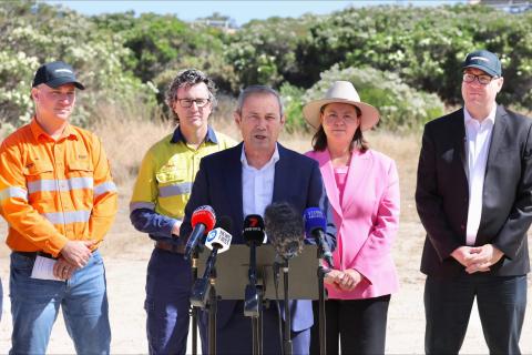 Roger Cook announced the state would pump $75 million into an electric ironmaking smelter at Kwinana, flanked by Tim Day (far left), Simon Trott, Madeleine King and David Michael.