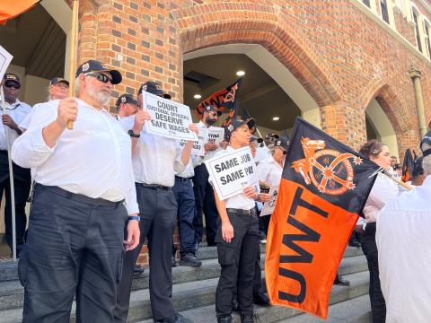 Ventia-employed court workers rally for better pay outside a WA Supreme Court building. AAP/Aaron Bunch 
