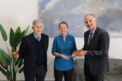 C/Prof David Blacker (right) handing Prof Merrilee Needham (middle) a reflex hammer and Prof Frank Mastaglia (Prof Needham's mentor and clinic founder, left) in the Perron Institute clinic.