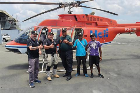 Augustus Minerals personnel flying to the Vanapa River site.