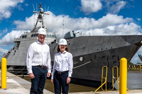 Paddy Gregg and Michelle Kruger in front of an Austal-built ship.
