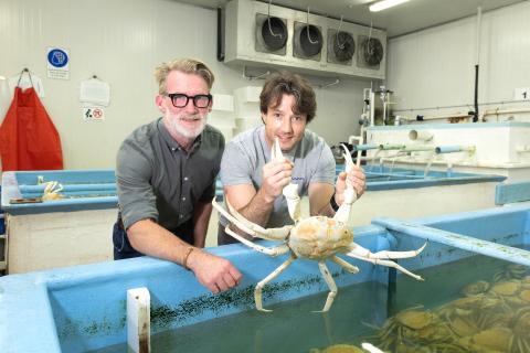 Steven Davies (left) with Sam Bass and a crystal crab. Photo: Michael O’Brien