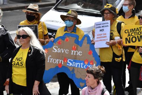 Protesters during a rally against oil and gas giant Santos outside the Federal Court in Sydney, Friday, April 8, 2022. Photo: AAP Image/DEAN LEWINS 
