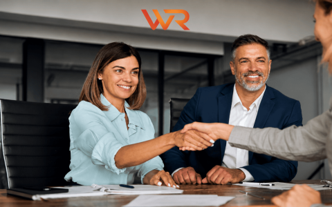 Business professionals shaking hands during a meeting.