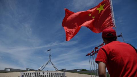 Man with Chinese flag outside federal parliament