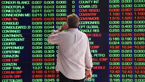 Person looks at ASX display board