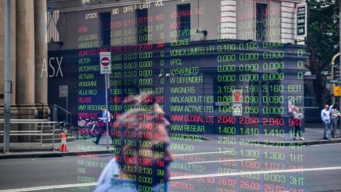 An ASX indicator board reflected ig glass (file image)