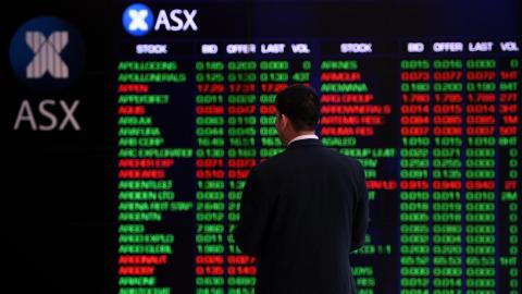 Person looks at ASX display board