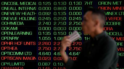 Person looks at ASX display board