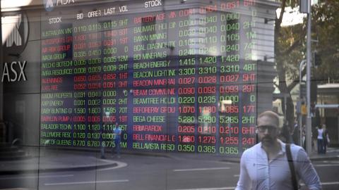 ASX indicator boards reflected in window in Sydney
