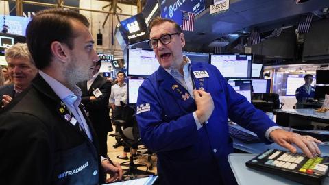 Wall St rises on jobs data optimism, Tesla rebounds