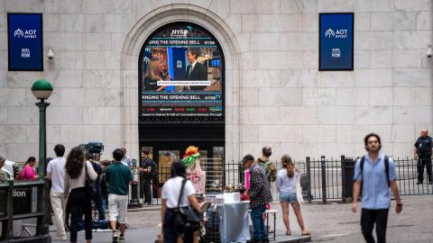 People walk past the New York Stock Exchange