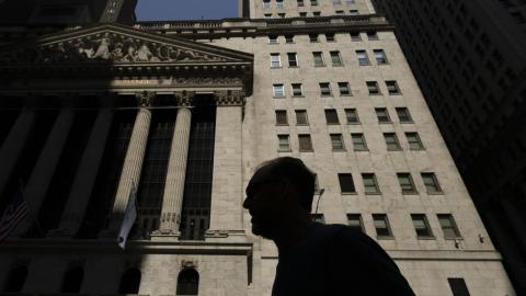 Man walks past the New York Stock Exchange
