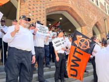 Ventia-employed court workers rally for better pay outside a WA Supreme Court building. AAP/Aaron Bunch 