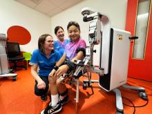 Cyrus using the robotic technology with PCH's Sam de Mol and Jenny Colegate