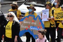 Protesters during a rally against oil and gas giant Santos outside the Federal Court in Sydney, Friday, April 8, 2022. Photo: AAP Image/DEAN LEWINS 