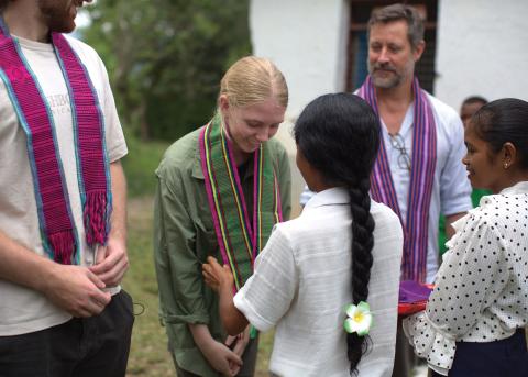 Mary McCusker receiving a hand woven tais at a UNICEF-supported community-based preschool in Ermera, Timor-Leste. Photo: ©UNICEF Timor-Leste/2025/NSoares